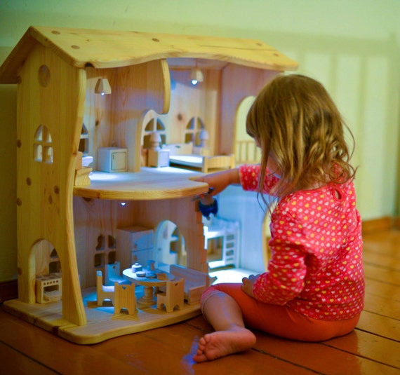 Wooden dollhouse without furniture. Christmas gift.
