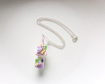 Fairy house necklace in pacy and lilac colours handmade from polymer clay