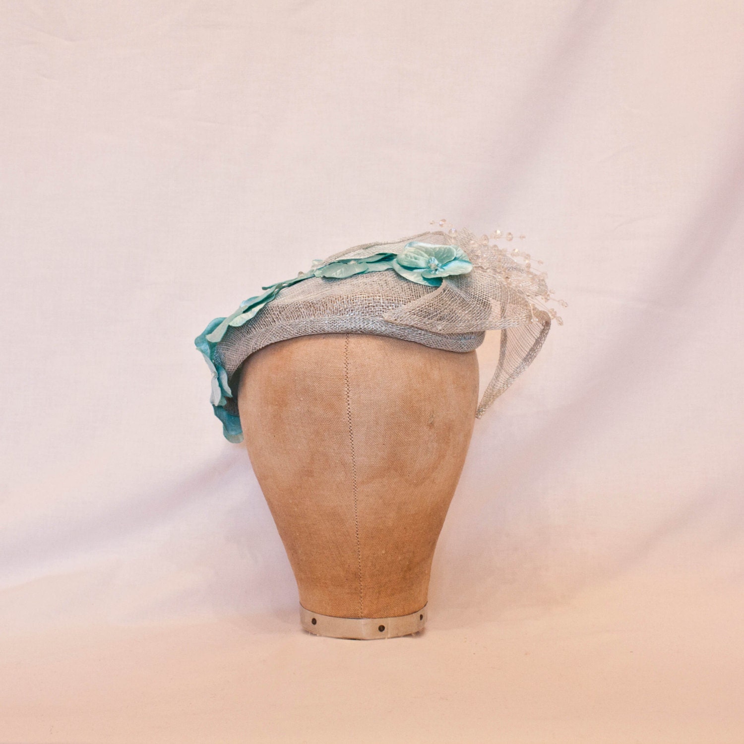 Handmade pale blue ladies occasion hat, decorated with delicate blue flowers