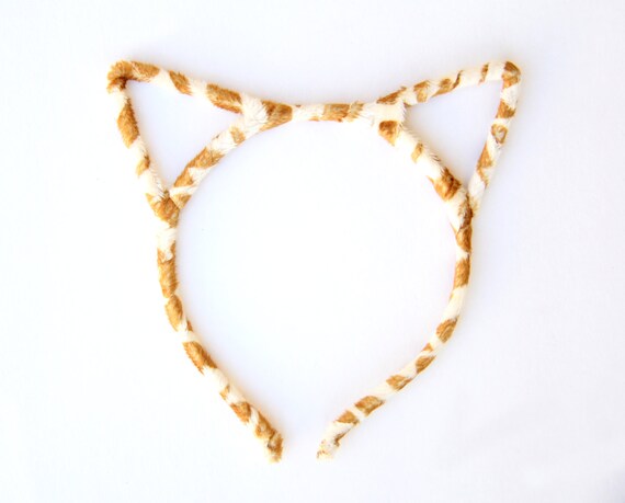 Kids cat ears headband Cat Ear Headbands. Channel cute feline spirit with our selection of cat ear headbands. This fierce and fun trend is the purr-fect finishing touch to your hairstyle. Our cat ears for girls come in all sorts of designs including: floral, bedazzled, light up, and more. If you find that your animal instincts are breaking through, animal ear.