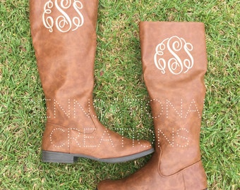 monogram plaque long leather boots