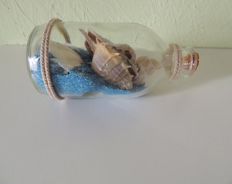 Art glass bottle, Mediterranean shells and sand