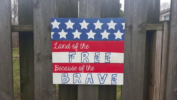 sign that reads land of the free because of the brave
