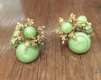 Vintage Miriam Haskell earrings with green glass stones 1950s designer signed.