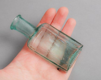 Antique small blue glass bottle, medical or laboratory bottle.