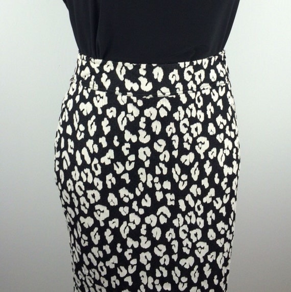 Shop By Country Pull-on style. Slim-fitting pencil skirt. All over leopard print. Knee-length. Zipper closure up the back. Small center slit on the back bottom hem. Smooth to the touch fabrication. Can be worn as a two-piece set with matching jacket. Model is wearing a plus size 28 in. 97% polyester. 3% spandex. Machine wash cold gentle cycle with like colors.