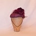 Plum/purple occasion hat decorated with rose, tulle and beading