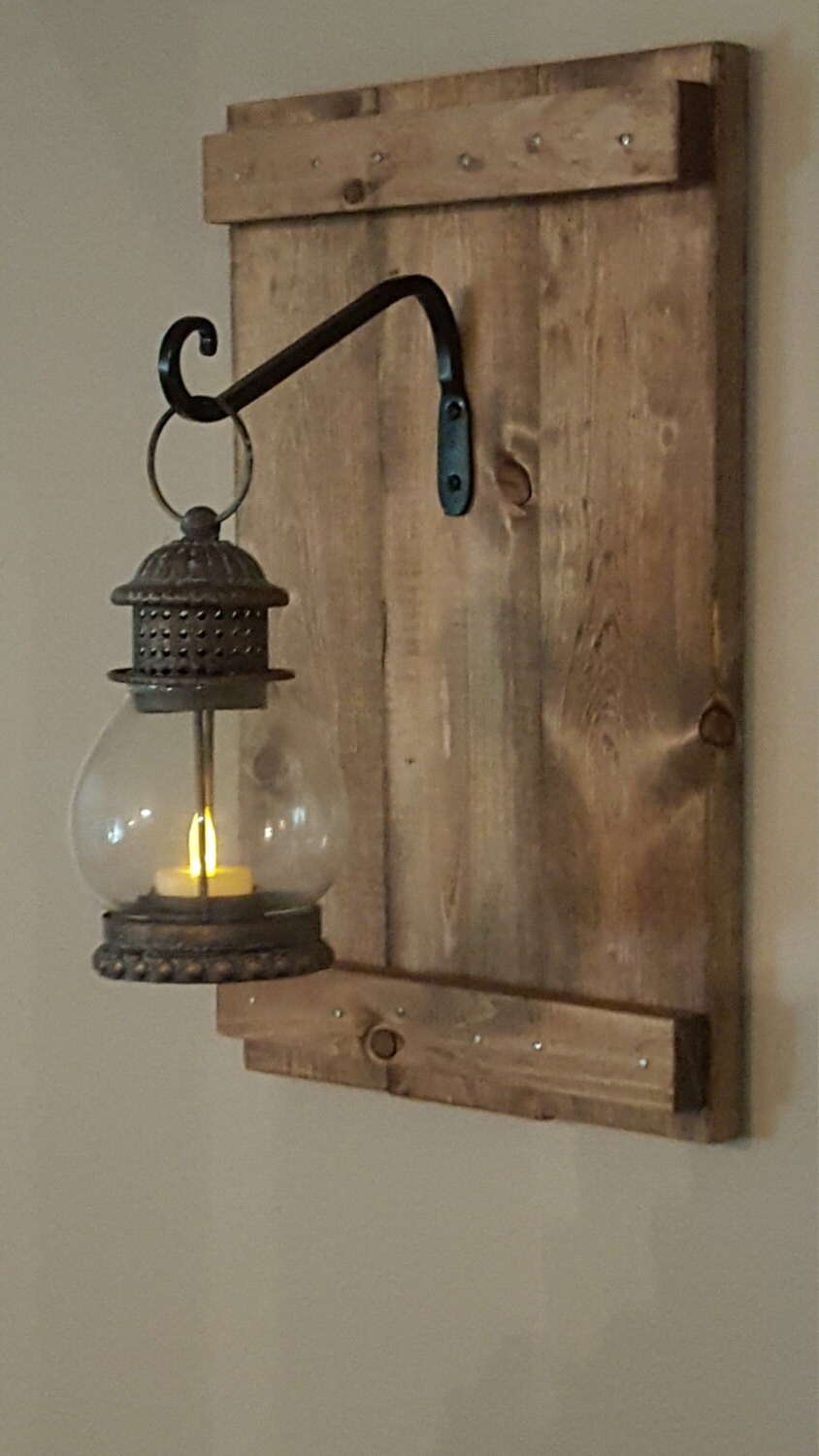 Bronze Lantern with wrought iron hooks rustic wood boards