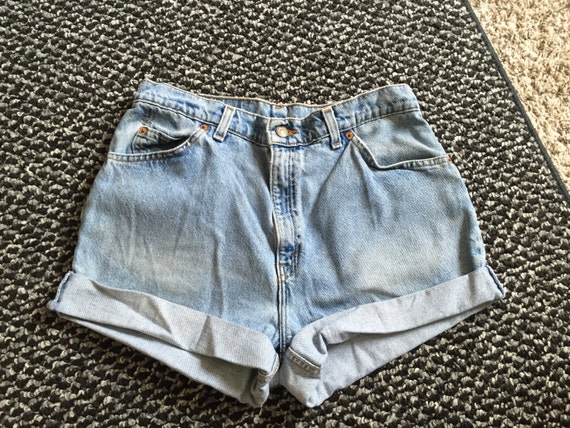 Light Wash High Waisted Shorts W Gladiators The Show Em Booty Denim Distressed Shorts are next level distressed in all the best places, with a high-rise waist, belt loops, zip fly button closure, non-functioning pockets, all-over extreme distressing, and frayed hem.