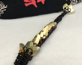 Pet Dragon made of anodized aluminum rings. All dragons come with a name and bio card.