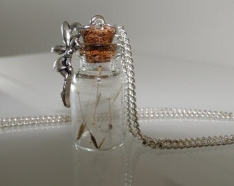 Small glass vials with dandelions and a little fairy