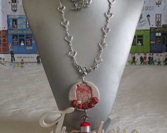 Collier plastron pendentif "La cage de l'oiseau avec un pompon"