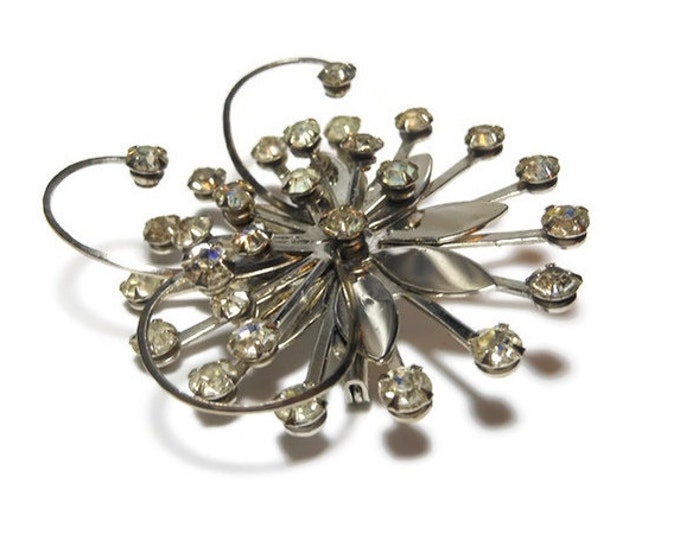 Rhinestone daisy brooch, clear rhinestones, silver tone flower, swirl pinwheel design, 1930s estimated age, faceted prong set