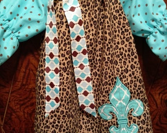 This peasant dress has Aqua Fleur de Lis on a Cheetah dress with aqua & brown dot quarter length sleeves.