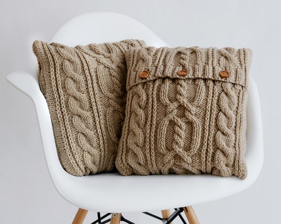 Beige cable knit pillow cover with 3 wooden buttons.