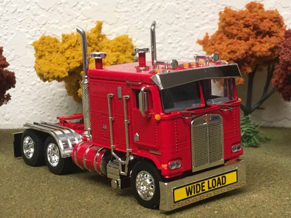 Dcp 1/64 Kenworth K100 cab over flat top semi new red diecast