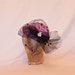 Handmade satin hat in clover purple decorated with polka dot spotted veiling and diamanté detail