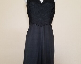 Black 1960's full slip by Vanity Fair. 100% Tricot Nylon. Size 38.