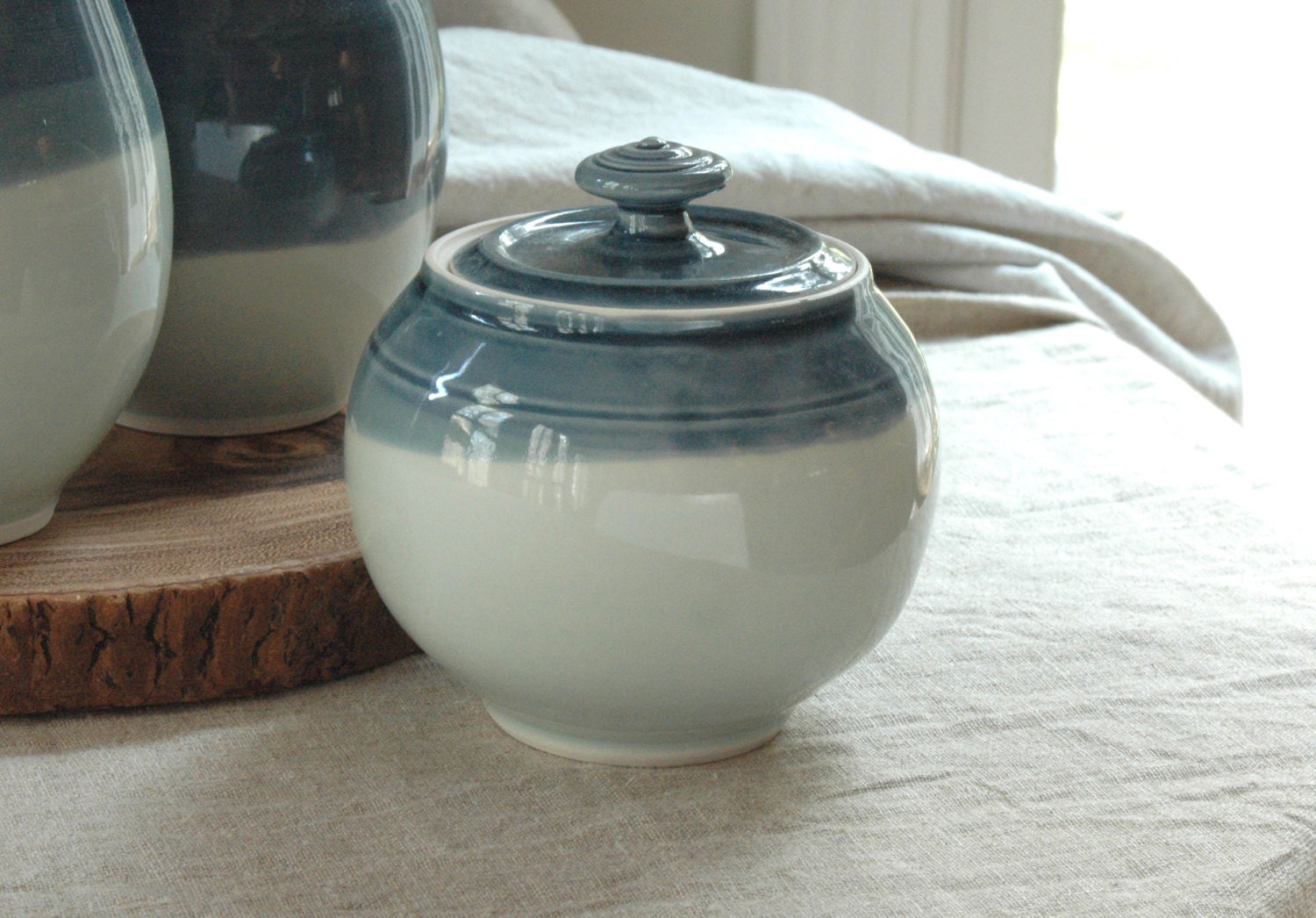 Small handmade porcelain lidded jar in deep blue and light