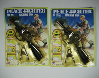 Free WW Shipping. Two (2) BRAND NEW Vintage 1970's Timmy Toys Peace Fighter Metal Machine Guns. 8 Shot Caps Guns.Nice Details Limited Stock