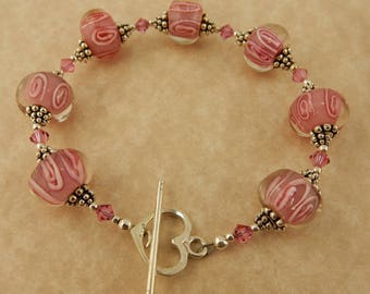 Awareness Bracelet with Pink lampwork glass beads with Swarovski crystals and a sterling silver heart toggle