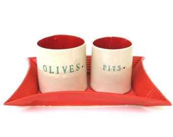 olives and pits  ....  hand built porcelain containers on a tray  ...  vessels and tray