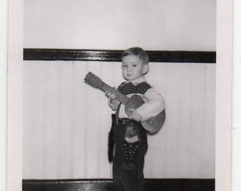 November 1954 Boy Wearing Cowboy Costume Holding Small Guitar Vintage Snapshot Children's Dress Up Photo Mid Century Modern Photograph