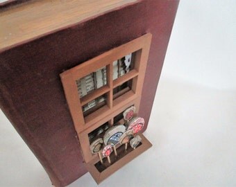 book sculpture with window and flowerbox