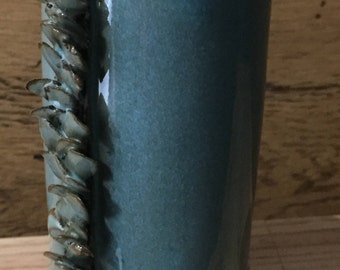 Warm green on red clay with petal decorations