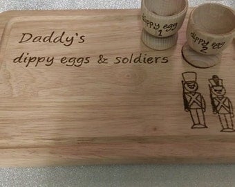 Personalised boiled eggs and soldiers board and cups.