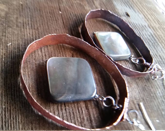 Copper Hoops, Hammered, Texture, and Heated for Patina. The drop is a Dark Mother of Pearl with lots of Colors Reflected in Them.