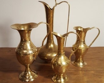 Vintage brass ewers, etched floral decoration.