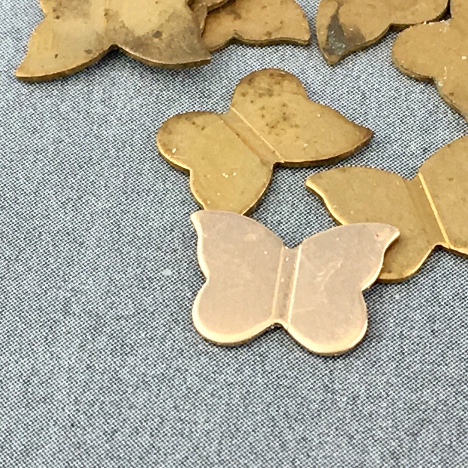 Ten small brass butterfly stampings from KimVSupplies on Etsy Studio