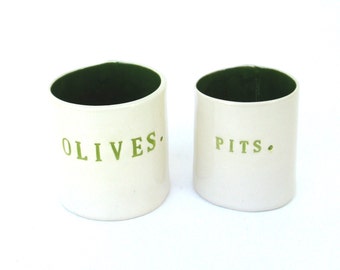 olives and pits  ...  hand built porcelain containers ...  bold green vessels