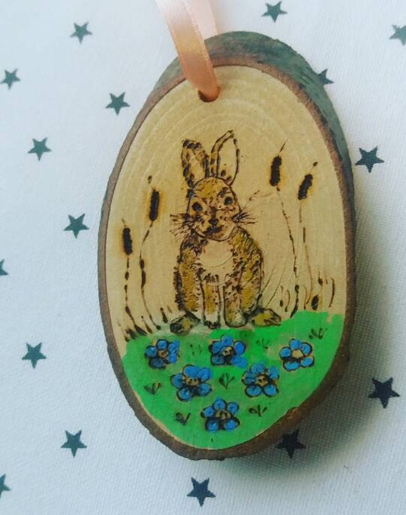 Bunny wooden handmade ornament with a satin ribbon.