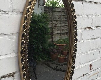 Gold oval mirror with lovely detail in the frame