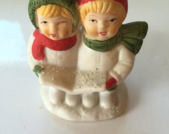 Vintage Christmas carolers in snow candle holder