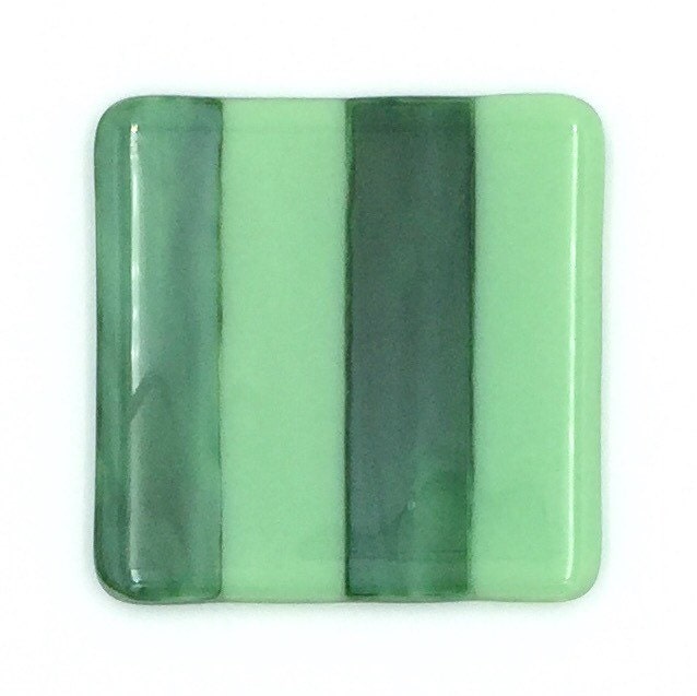 Glass coasters in forest green and mint green glass with a