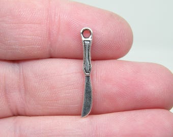 10 Silver Tone Knife Charms. B-010
