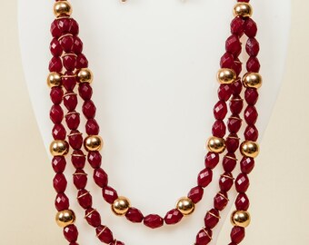 Maroon and gold beaded necklace.