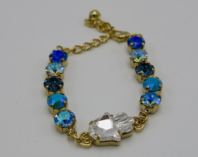 Crystal hand Hamsa in boho blue bracelet featuring an ombre of Swarovski crystal set in yellow gold. Sapphire blue crystals