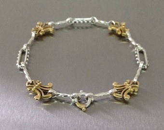 Silver and Gold fleur de lis bracelet.