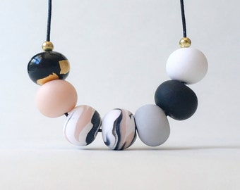 Beaded black, pink and gold polymer clay necklace