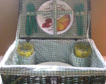 Vintage green wicker fully stocked picnic basket.