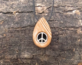 Olive wood pendant with two inlaid peace symbols