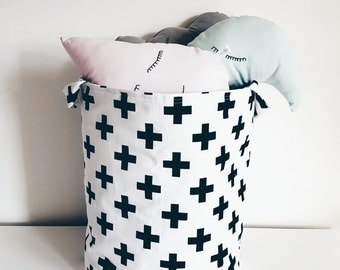 Fabric storage basket, organizer. Laundry basket, toy storage, black swiss cross on white background. Monochrome. Nursery decor, kids room.