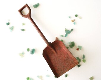 Vintage toy shovel, rusty metal shovel, red toy shovel, toy sand shovel