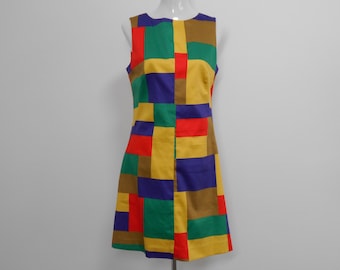 Sleeveless, cotton 1960's style A-line dress has center font seam, fitting darts and back zipper