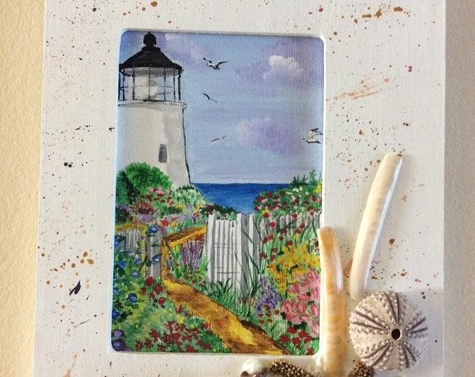 Framed acrylic lighthouse, decorated with seashells