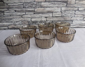A set of 6 smoked glass ramekins Arcopal the ramekins have the BP logo on the base
